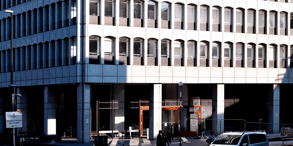 People walking beside concrete building